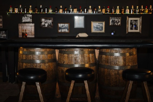 Prohibition-era-themed Speakeasy bar & lounge with vintage whiskey barrels