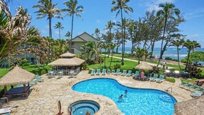 A pool area with lounge chairs, a hot tub, and a view of the ocean. - New from Premier Host -  Top Floor Oceanview Studio at Islander on the Beach (Kapaʻa)