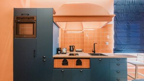 A compact kitchen with a built-in oven, a sink, and a stove. - Mantzarou #6 - Corfu Town Luxury Suites

 (Kerkira)