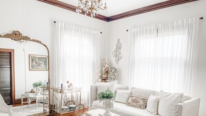 A white-themed living room with a sofa, coffee table, and decorative items. - Sandusky's Original Luxury Bachelorette Mansion  (Sandusky)