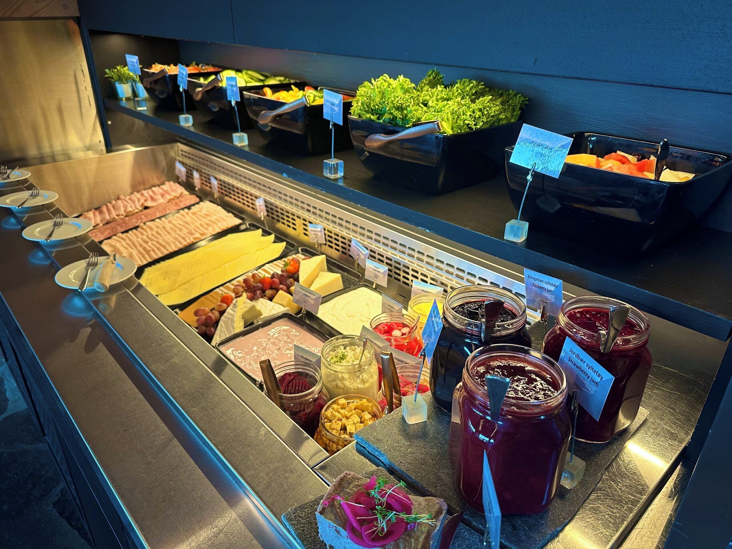 A buffet with various food items and condiments.