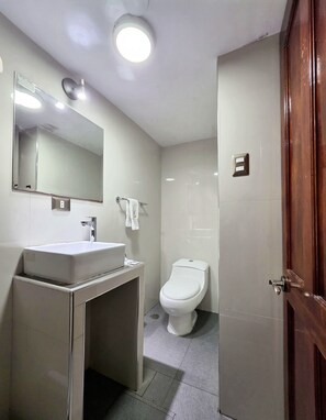 A bathroom with a white sink, mirror, and toilet. - Hotel Wayna Inka Classic (Cusco)