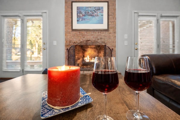 A cozy room with a fireplace, a table with a candle and two glasses of red wine, and a couch. - +Golf cart +Jacuzzi + Ping Pong + 0.6 miles to Historic Village and Pinehurst #2 (Pinehurst)