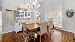 A dining room with a wooden table and chairs, a chandelier, and a white cabinet with glass doors. - +Golf cart +Jacuzzi + Ping Pong + 0.6 miles to Historic Village and Pinehurst #2 (Pinehurst)