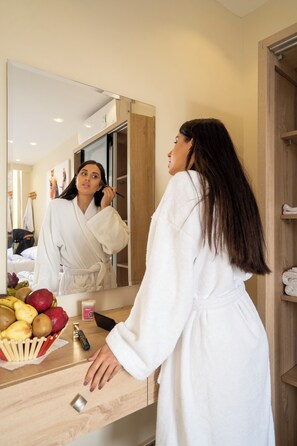 A room with a wooden vanity, a mirror, and a fruit basket on the counter. - King of Pharaohs Pyramids View (Giza)