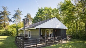 A cabin with a covered porch, a chimney, and a deck. - Beautiful home in Toftlund with WiFi (Toftlund)