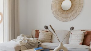 A modern living room with a sofa, a coffee table, and decorative items.