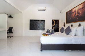 A modern bedroom with a large bed, a wall-mounted air conditioner, a ceiling fan, and a large Buddha painting. - Bungalow - Sleeps 2 - Terrace - Beach Close (Ko Lanta)