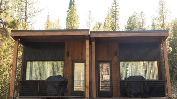 A modern two-story building with large windows and a covered outdoor area. - NEW Mountain Modern Cabin (Unit 4) (Island Park)