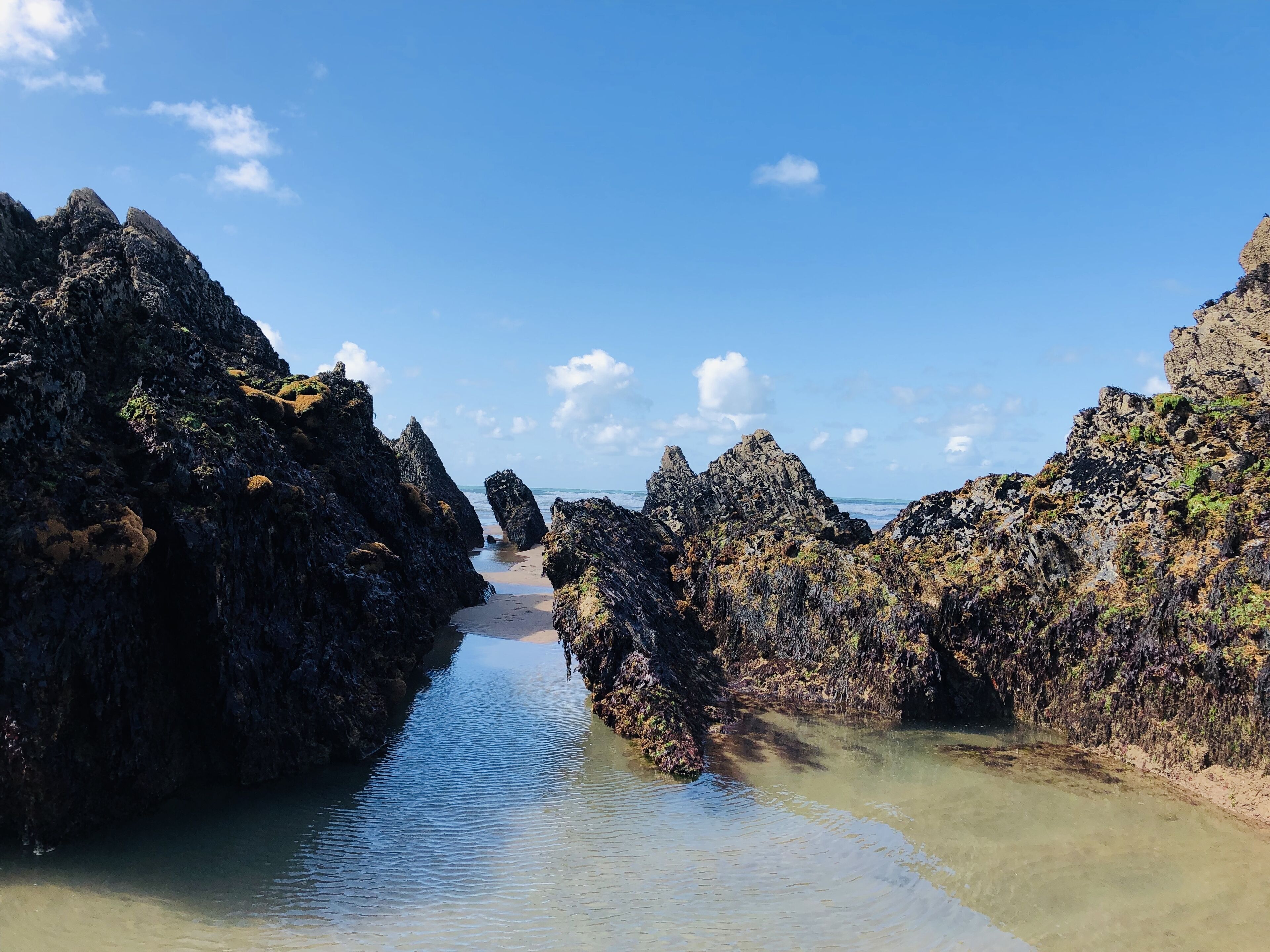A rocky coastal landscape with a narrow water channel.