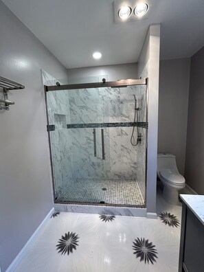 A modern bathroom with a glass-enclosed shower, a toilet, and a sink. - Unplug and unwind at your Leonardtown waterfront vacation home! (Leonardtown)