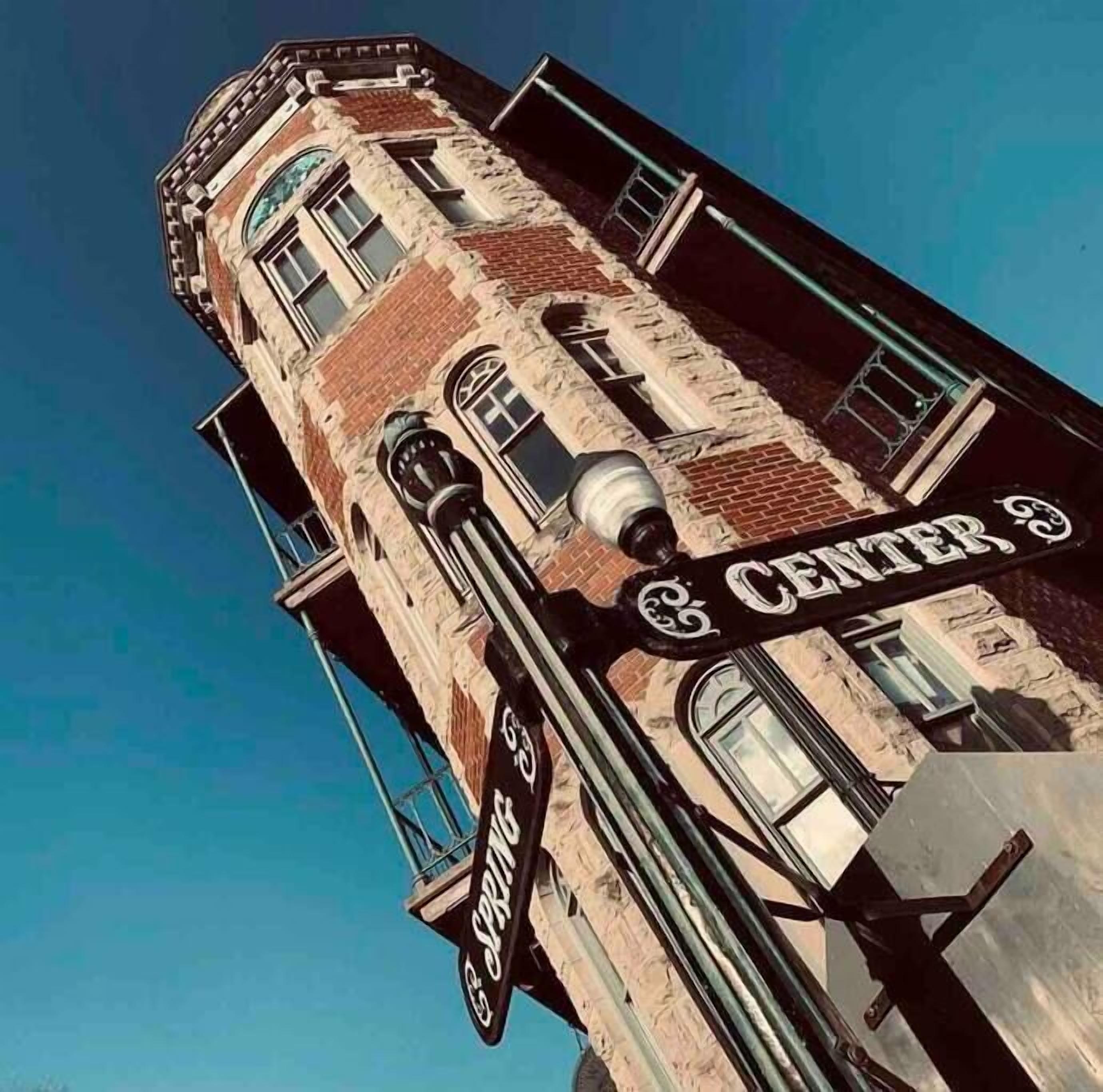 A tall building with a brick facade and a sign reading "CENTER".