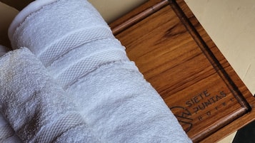 A white towel on a wooden tray with the text "Siete Puntas Hotel".