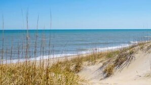 A beach with clear skies and calm waters.
