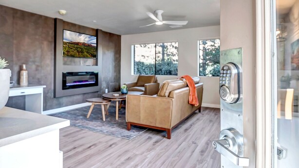 A modern living room with a sofa, a coffee table, and a fireplace.