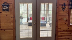 A wooden cabin with a sign above the door reading "LOVIN' THE LAKE LIFE". - Boo Boo's Cabin - Charming Lake Front Cabin located 5 miles to Helen, GA!  (Cleveland)