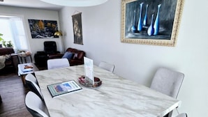 A dining area with a marble table, modern chairs, and a pendant light. - Pikes Peak Panorama View (Colorado Springs)