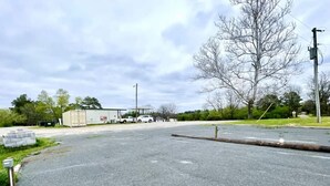 An empty parking lot with a building in the background. - Full hookups and WIFI RV spots  (Jerusalem)