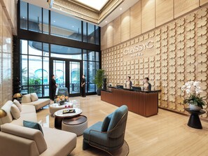 A hotel lobby with a reception desk, seating area, and large windows. - CLASSYC Hotel (Hanoi)