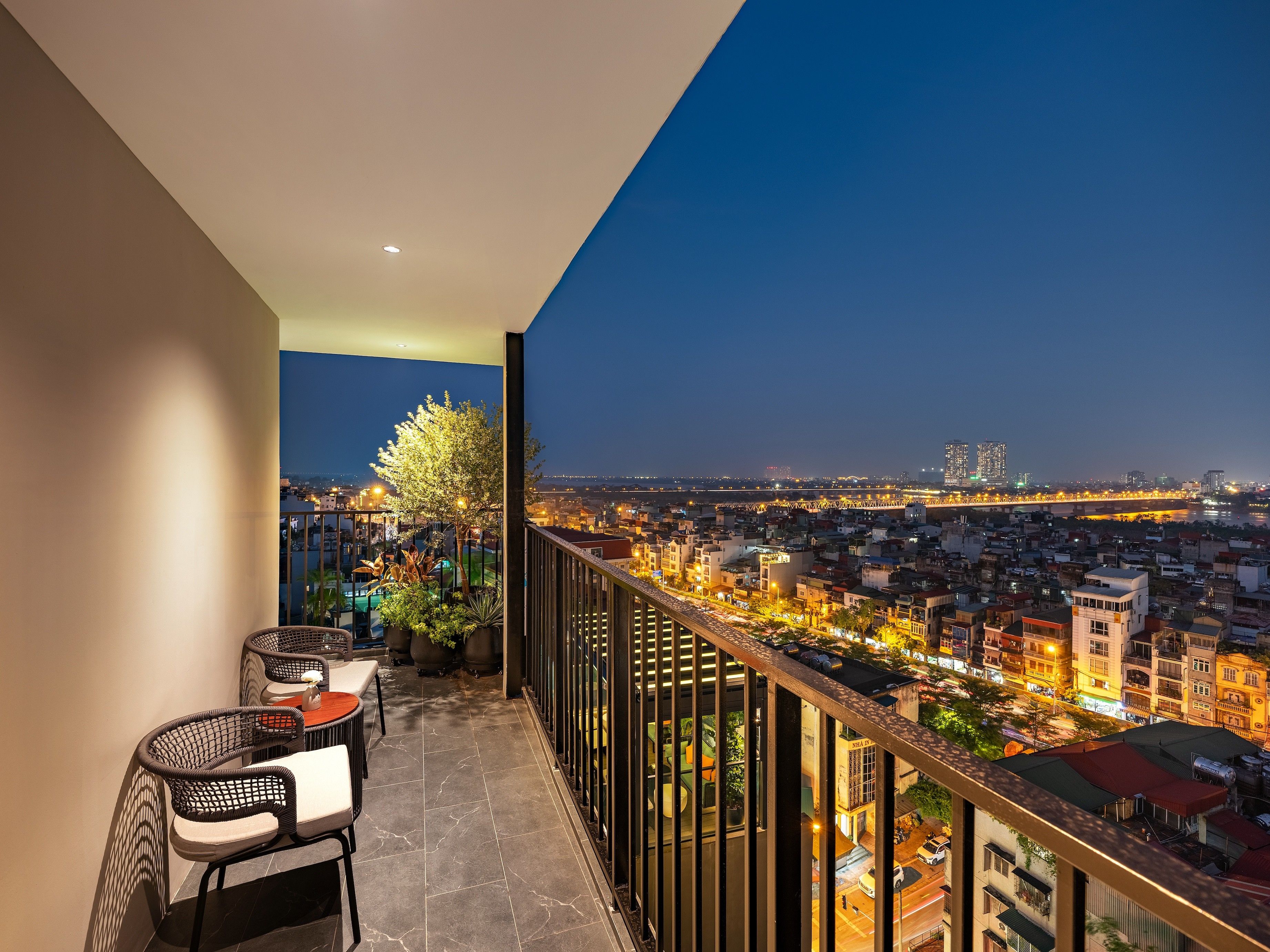 A balcony with a view of a cityscape at night.