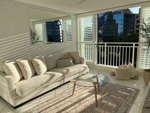 City Apartment | Living area | 55-cm Smart TV with satellite channels, Netflix, streaming services - Condor Surfers - Coastal Letting Co (Surfers Paradise)