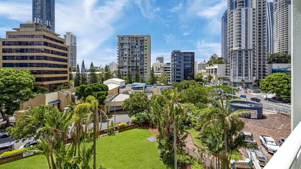 A high-rise urban area with modern buildings, a well-maintained lawn, and a clear sky. - Condor Surfers - Coastal Letting Co (Surfers Paradise)