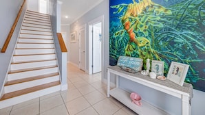 A staircase with wooden steps and a white wall. - Steps 2Beach~Heated Pool~Hot Tub~MiniGolf~Gameroom! (Panama City Beach)