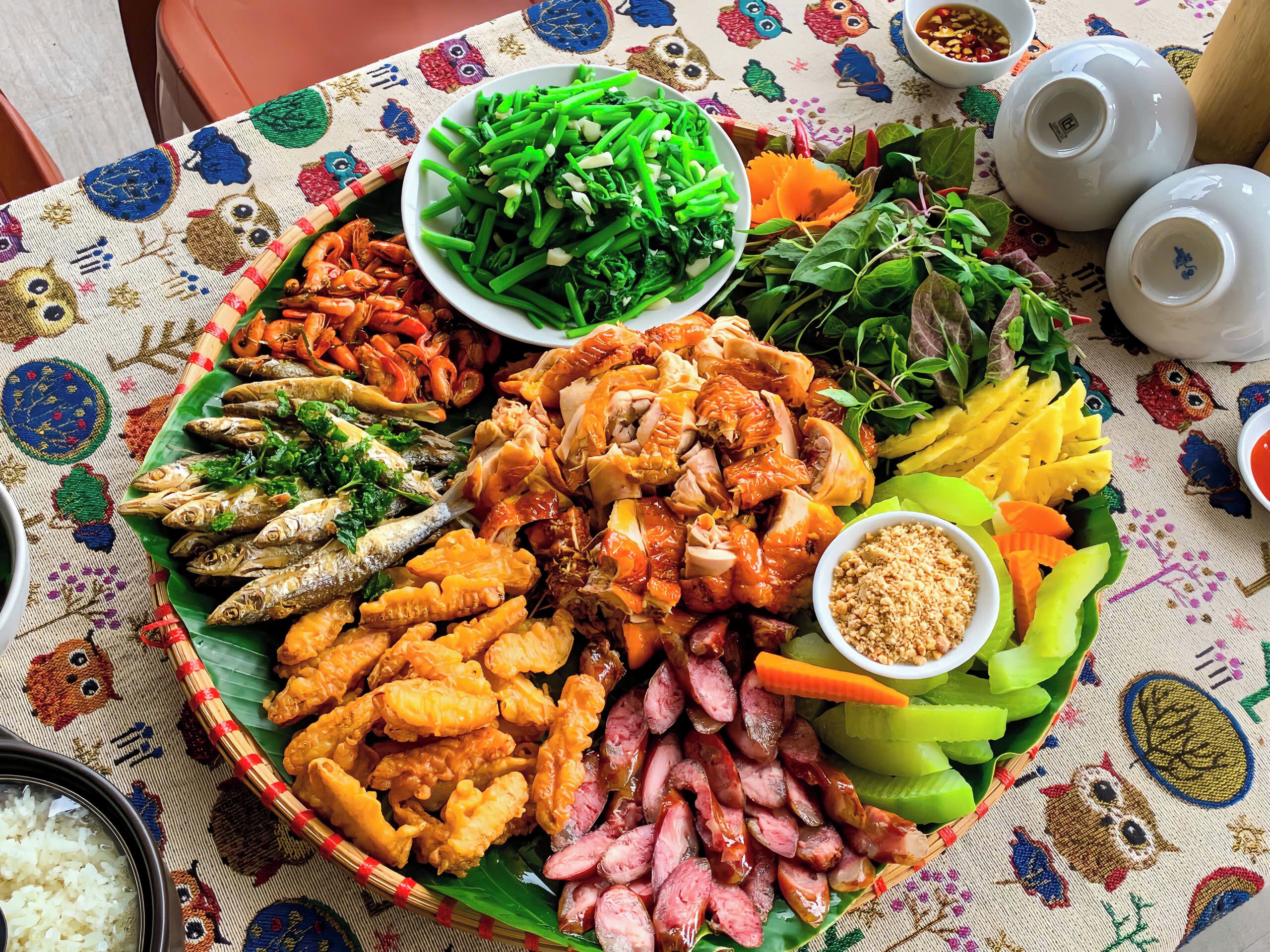 A table with various dishes including seafood, vegetables, and rice.