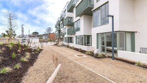 A modern building with balconies, large windows, and a gravel pathway. - The Lookout by Dublin At Home (Dublin)