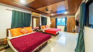 A hotel room with two beds, wooden ceiling, and large windows. - Strawberry County (Mahabaleshwar)