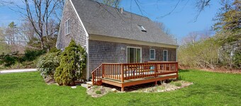 2-story home near the beach with large lawn, deck, W/D, streaming, & partial AC