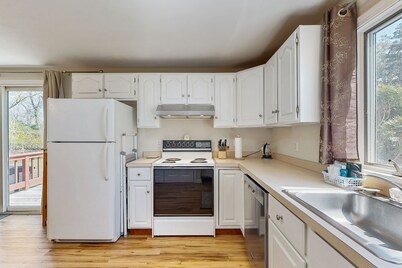 2-story home near the beach with large lawn, deck, W/D, streaming, & partial AC