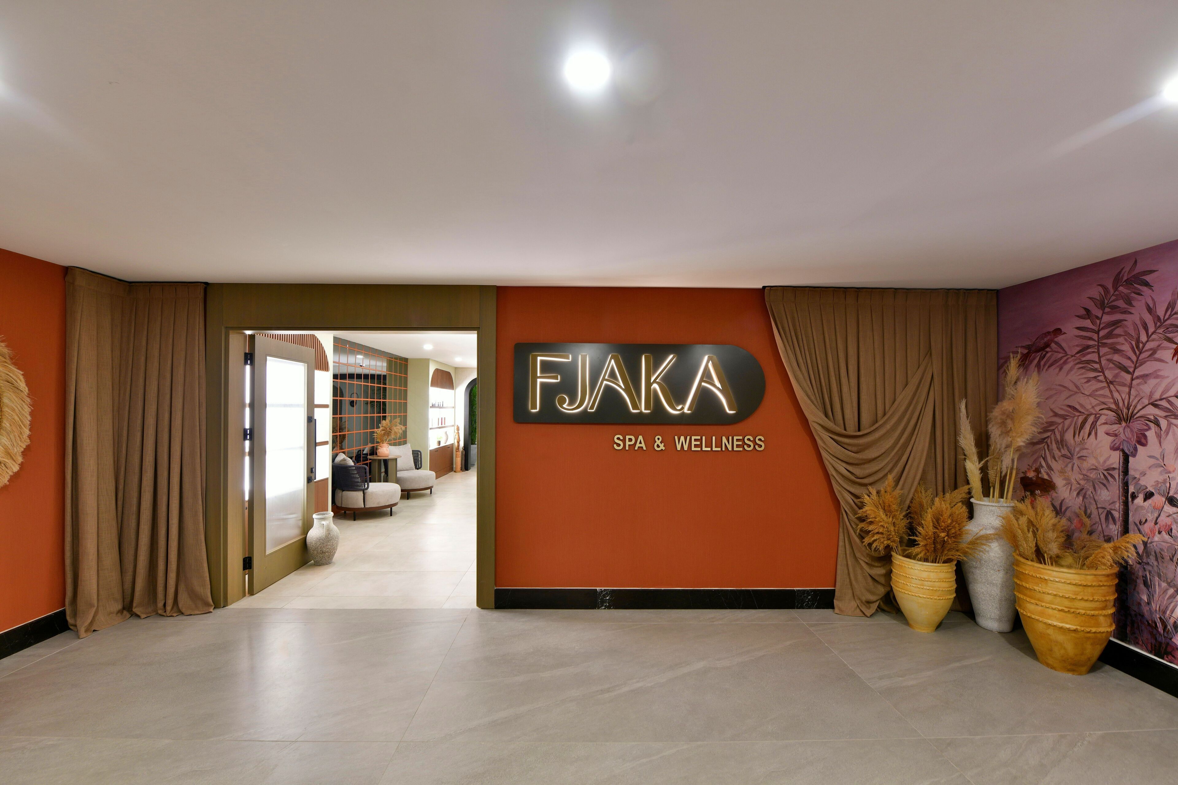 A modern interior with a sign for 'FIJAKA SPA & WELLNESS'.