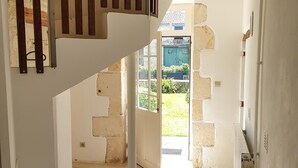 A staircase leading to a door with a view of a garden outside. - Cottage (sleeps 6) at Domaine de Chantageasse, a 17th century estate with pool (Asnières-la-Giraud)