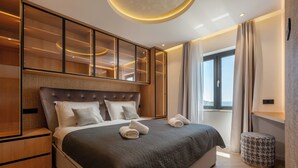 A modern hotel room with a large bed, a built-in wardrobe, and a view of the city. - Old City Viewpoint by Dubrovnik view (Dubrovnik)