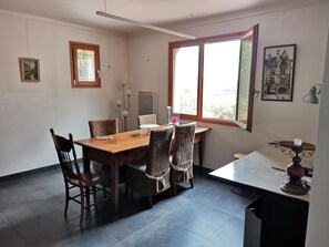 Enjoy meals in this cozy dining area with a large wooden table and six comfortable chairs.