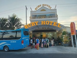 The entrance to Ruby Hotel with a prominent archway and a group of people standing outside. -  Ruby Hotel Phan Thiet (Tien Thanh)