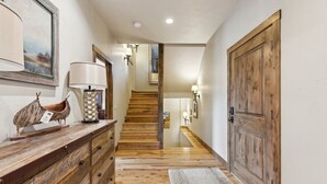 A wooden staircase with a wooden floor leading to a second floor. - Ski-in/Ski-out Access and Private Hot Tub (Whitefish)