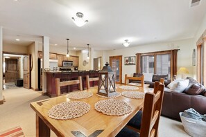 Enjoy meals together at the dining table, surrounded by a comfortable sofa and kitchen amenities.
