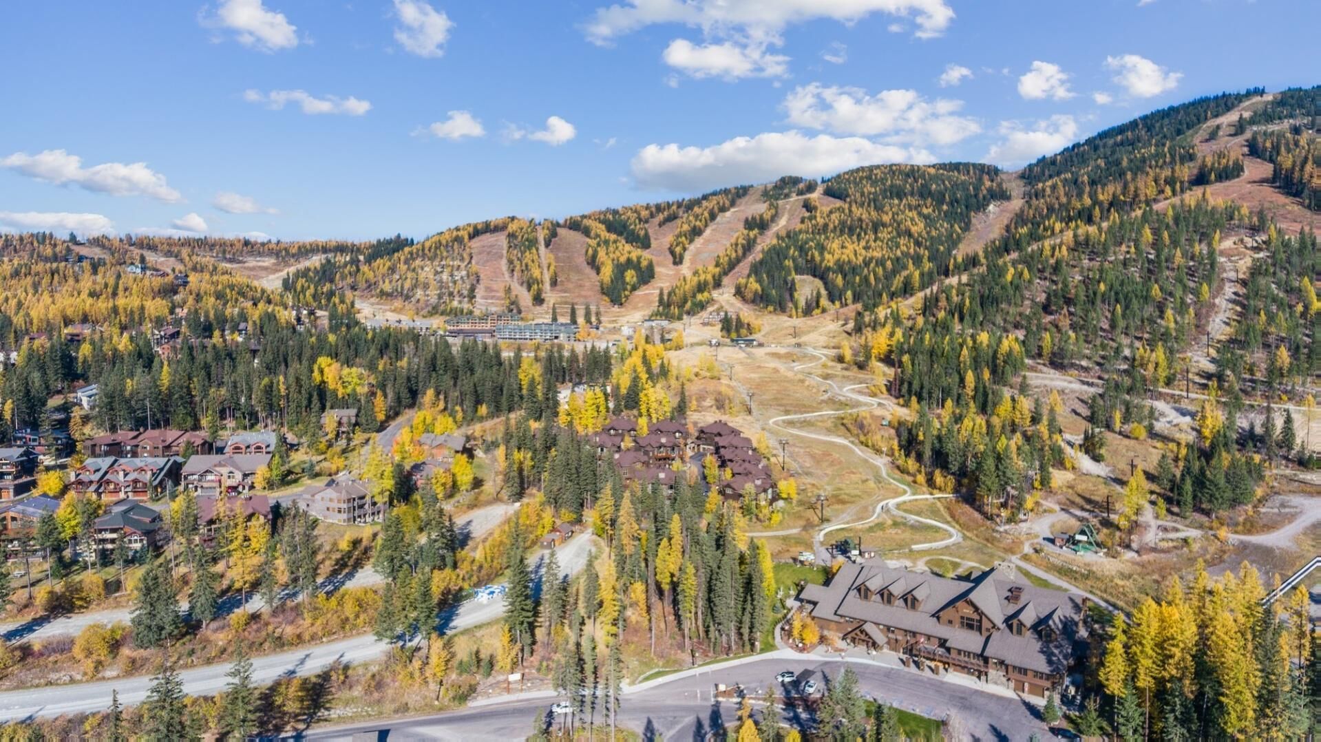 A mountainous area with a ski resort, including buildings and winding roads.