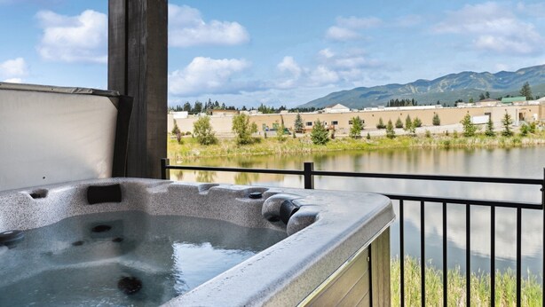 A hot tub with a view of a lake and mountains. - Ski Room | Mountain Views | Hot Tub (Whitefish)