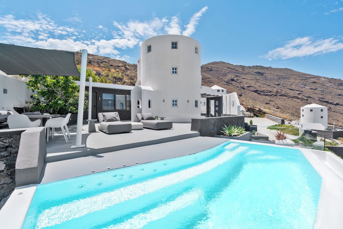 A modern pool area with a clear view of the surrounding architecture and landscape.