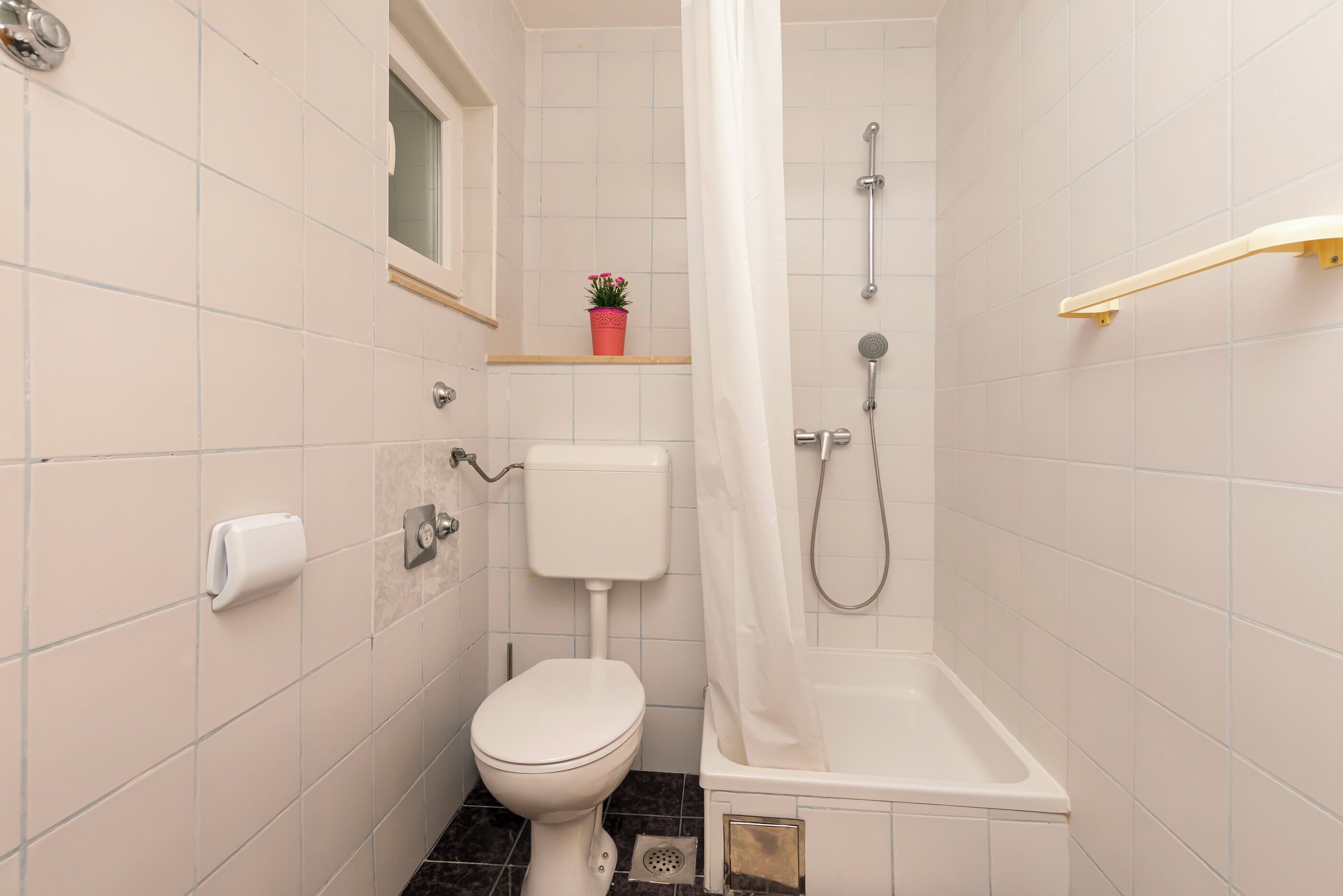 A bathroom with a toilet, a shower, and a bathtub.