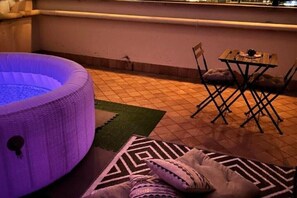 A room with a heated floor, a small table with chairs, and a patterned rug.
