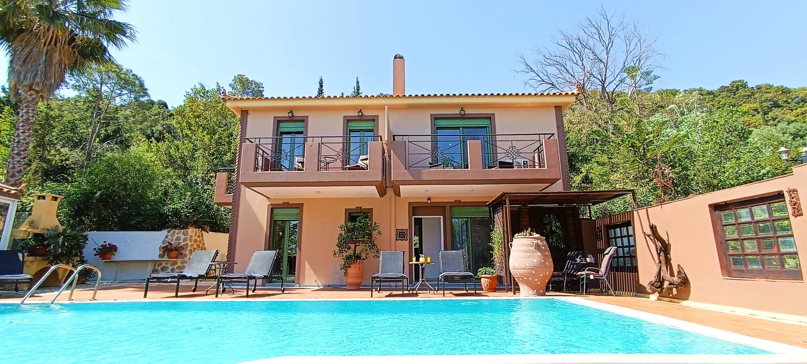 A two-story building with a swimming pool in front.