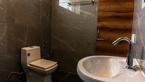 A modern bathroom with a toilet, bidet, and sink. - Winter Stone (Dharamshala)
