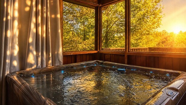A hot tub with a view of trees through large windows. - Sneaky Bear Getaway, Hot Tub, WIFI,  $560 FREE tickets each paid day!!! (Sevierville)