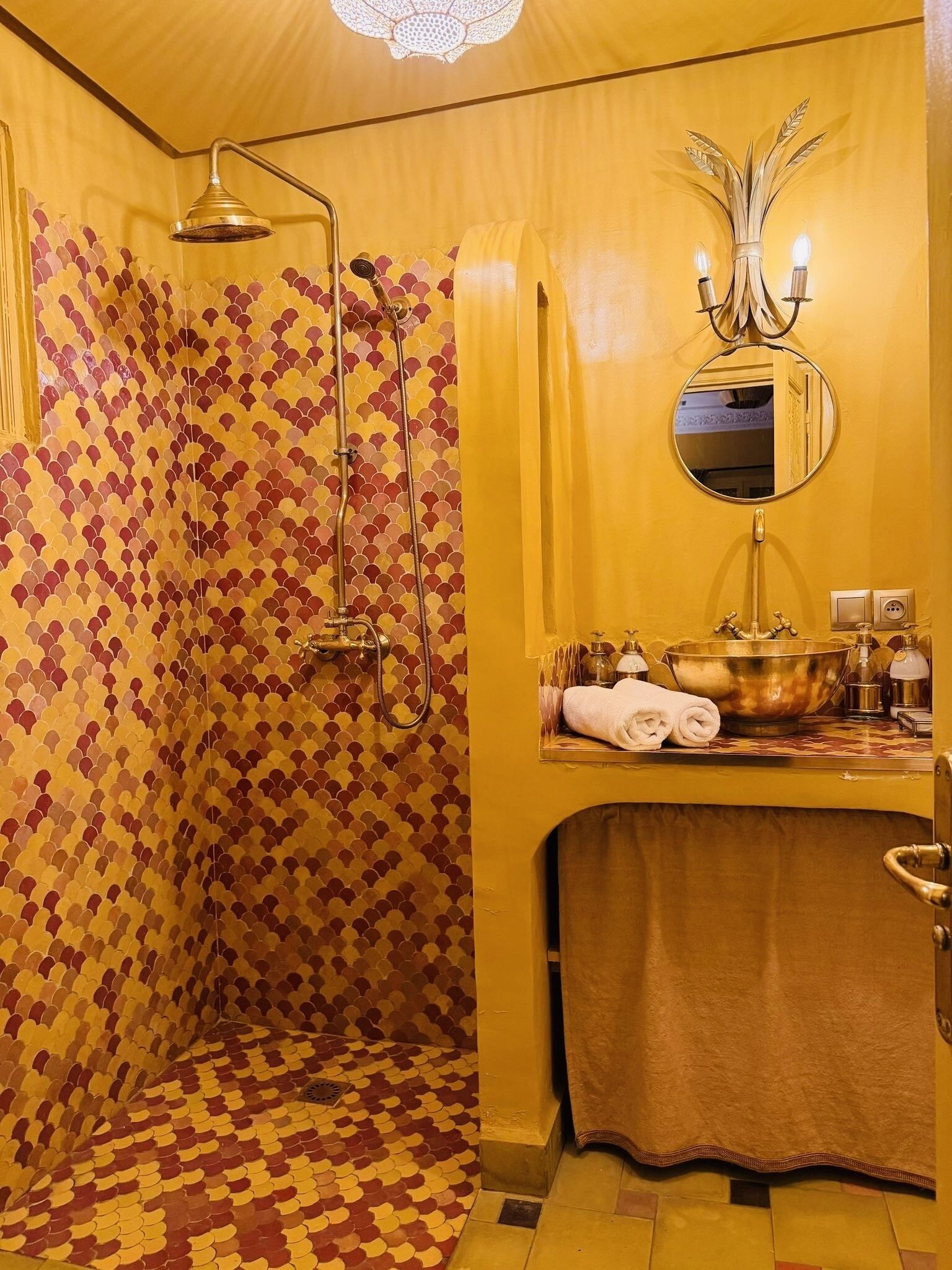 A bathroom with a shower, a sink with a mirror, and a towel rack.