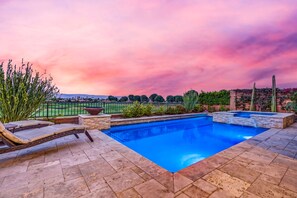A swimming pool with a view of a landscaped garden and distant hills. - Exclusive Escape: Poolside Luxury near Scenic Golf (La Quinta)