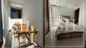 A bedroom with a bed, a window, and a door.